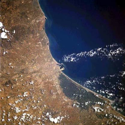 Situated on the east coast of the Iberian Peninsula, Valencia (near center of image) is the capital of the Valencia Autonomous Region, as well as a major port in Spain.  With an estimated 800,000 people, this historic and picturesque city is the third largest city in Spain.