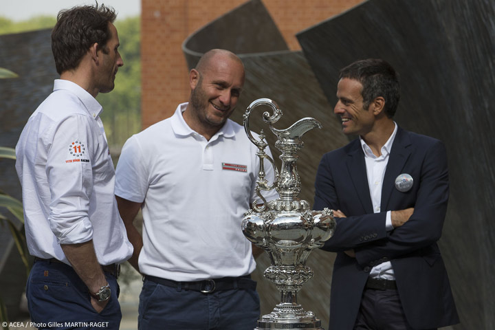 Ben Ainslie (GBR), Max Sirena (ITA), and Franck Cammas (FRA), gather round the Cup in London, Tuesday.