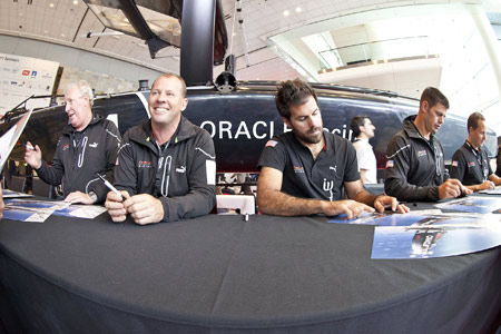 Crew signing autographs at Oracle World. Photo:2011 Guilain Grenier/Oracle Racing